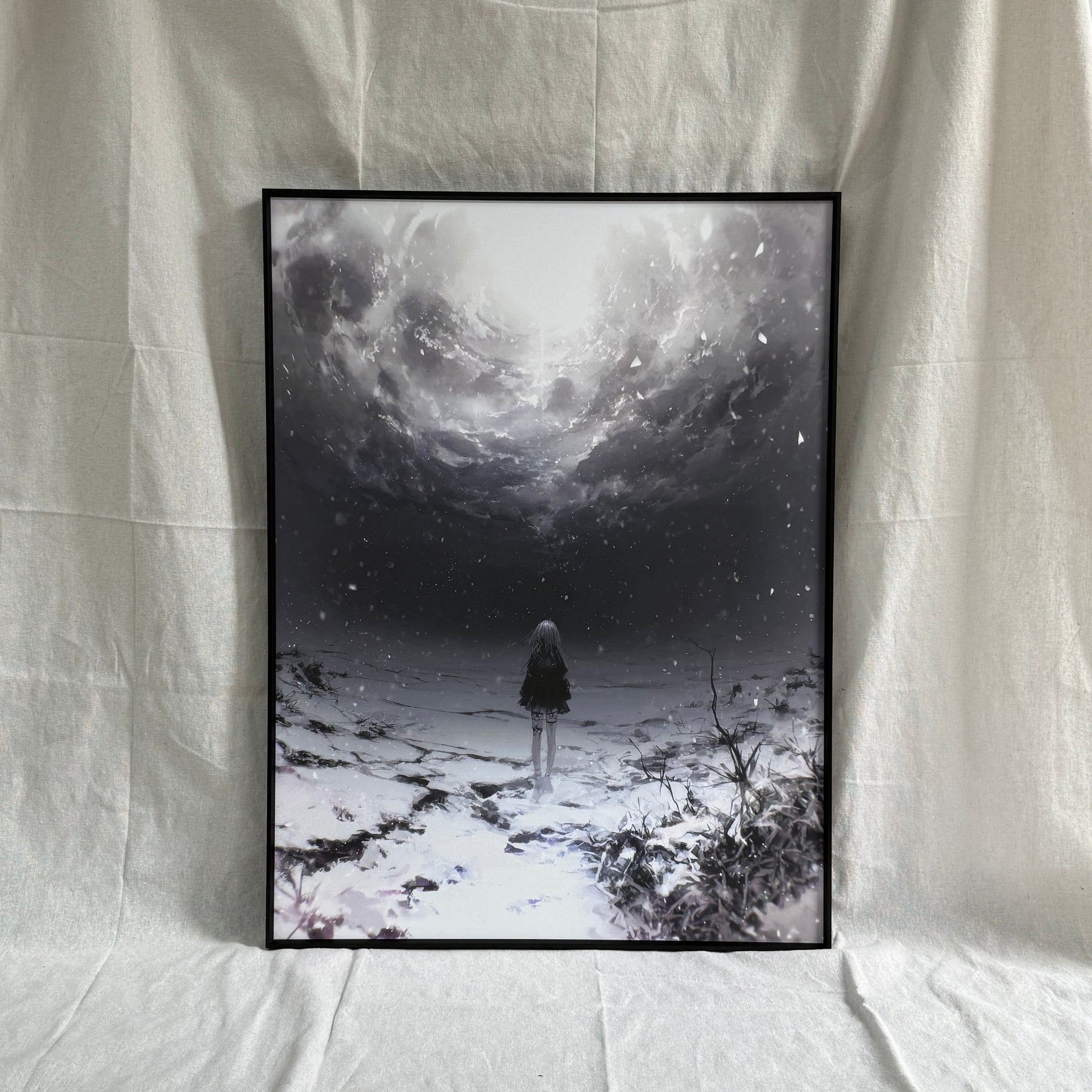 Framed artwork of a person standing in a snowy landscape with a large sun in the sky, displayed on a white fabric background.